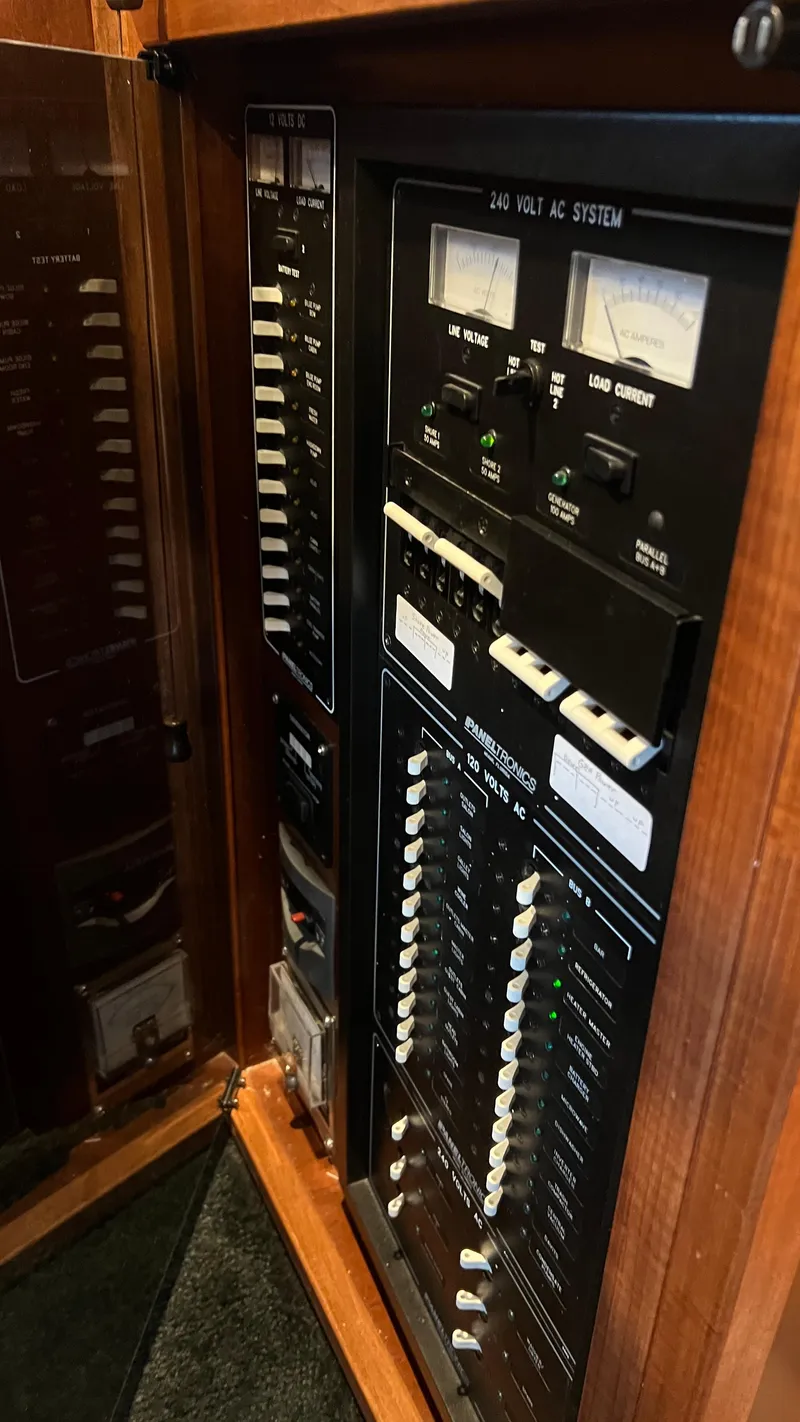 Slide: The Image of Electrical control panel inside 2008 Monticello River Yacht, featuring switches and meters. - 52