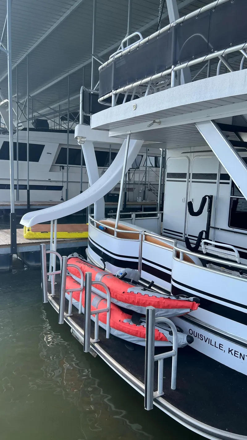 Slide: The Image of 2008 Monticello River Yacht with slide and kayaks docked in Louisville, Kentucky marina. - 62