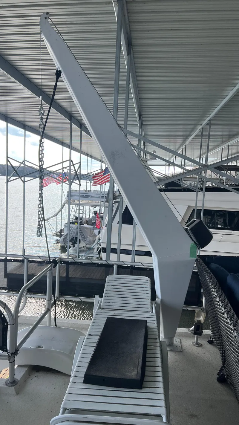 Slide: The Image of 2008 Monticello River Yacht docked under covered marina with American flags. - 64