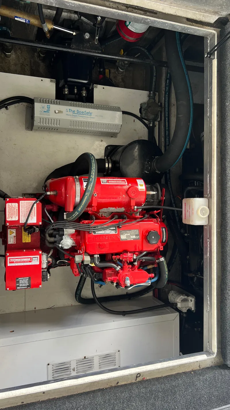 Slide: The Image of Engine compartment of a 2008 Monticello River Yacht with red machinery and components. - 76