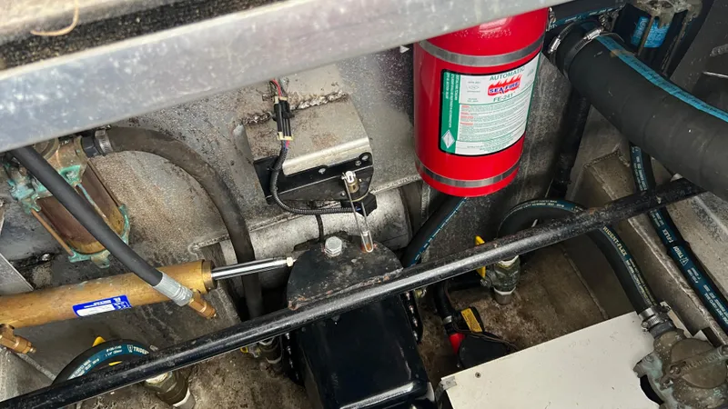 Slide: The Image of Engine compartment of 2008 Monticello River Yacht with fire extinguisher and hoses. - 78
