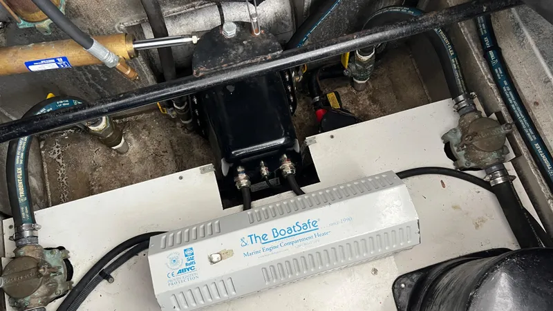 Slide: The Image of Engine compartment of 2008 Monticello River Yacht with marine heater and hoses. - 80