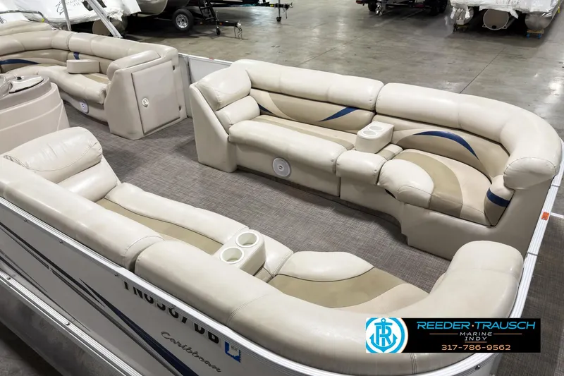 Slide: The Image of 2006 Crest Caribbean 2570 pontoon boat interior with beige seating and cup holders. - 10
