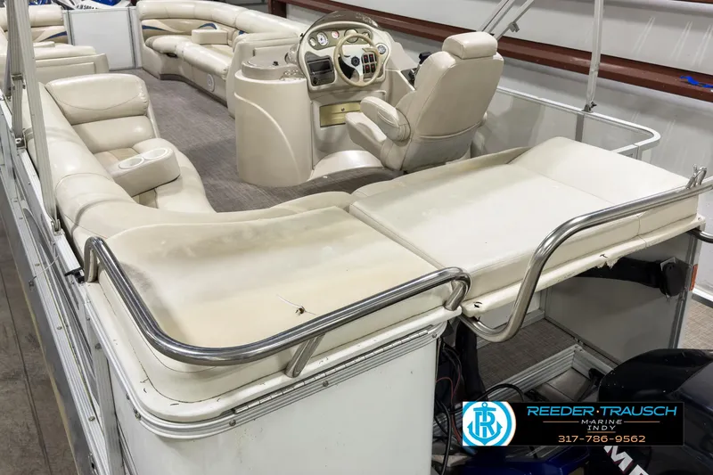 Slide: The Image of 2006 Crest Caribbean 2570 pontoon boat interior with beige seating and steering console. - 12