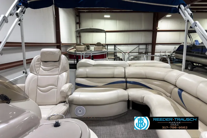 Slide: The Image of 2006 Crest Caribbean 2570 pontoon boat with beige seating in indoor storage. - 15