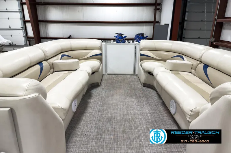 Slide: The Image of 2006 Crest Caribbean 2570 boat interior with beige seating in a showroom. - 17