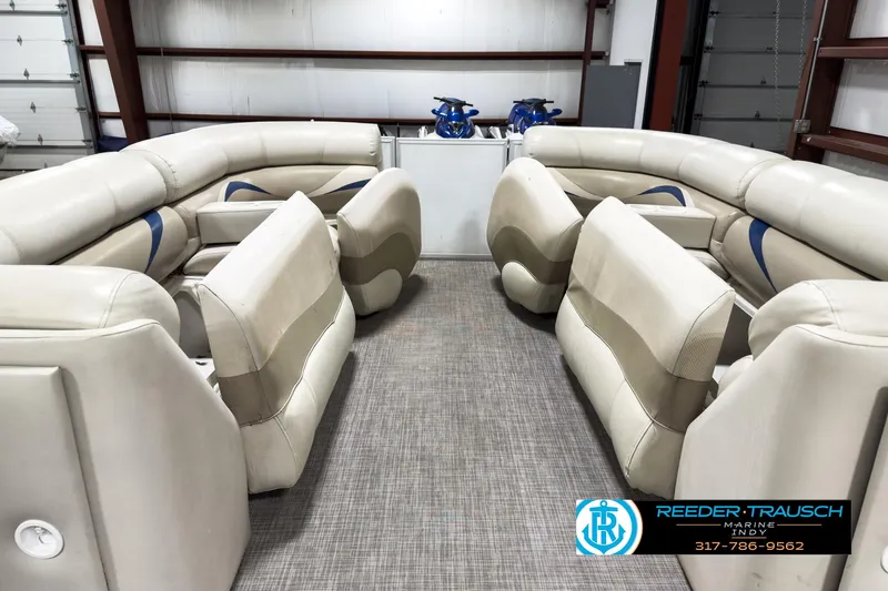 Slide: The Image of 2006 Crest Caribbean 2570 boat interior with beige seating and carpet flooring. - 18