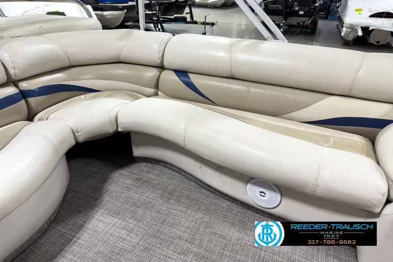 Slide: The Image of 2006 Crest Caribbean 2570 boat interior with beige seating and blue accents. - 19
