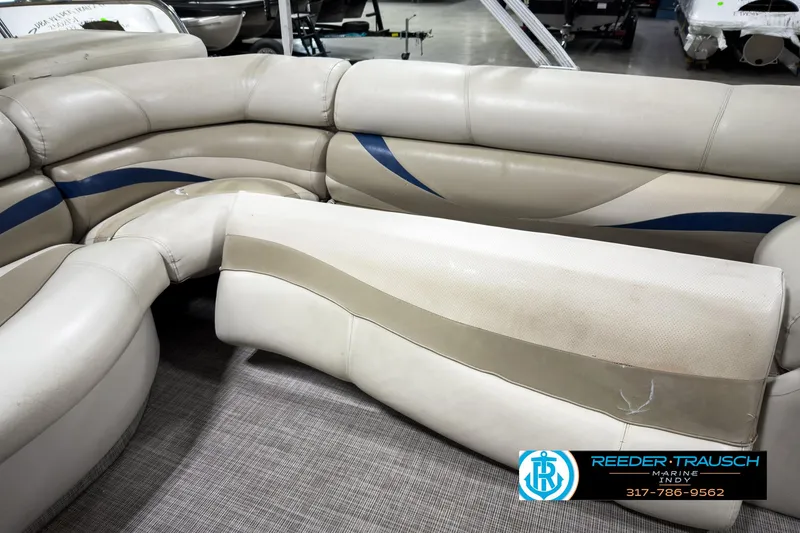 Slide: The Image of 2006 Crest Caribbean 2570 boat interior with beige and blue seating. - 20