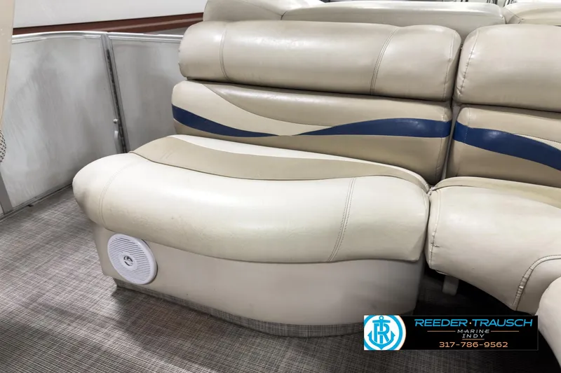 Slide: The Image of 2006 Crest Caribbean 2570 boat seating with beige upholstery and blue accents. - 21