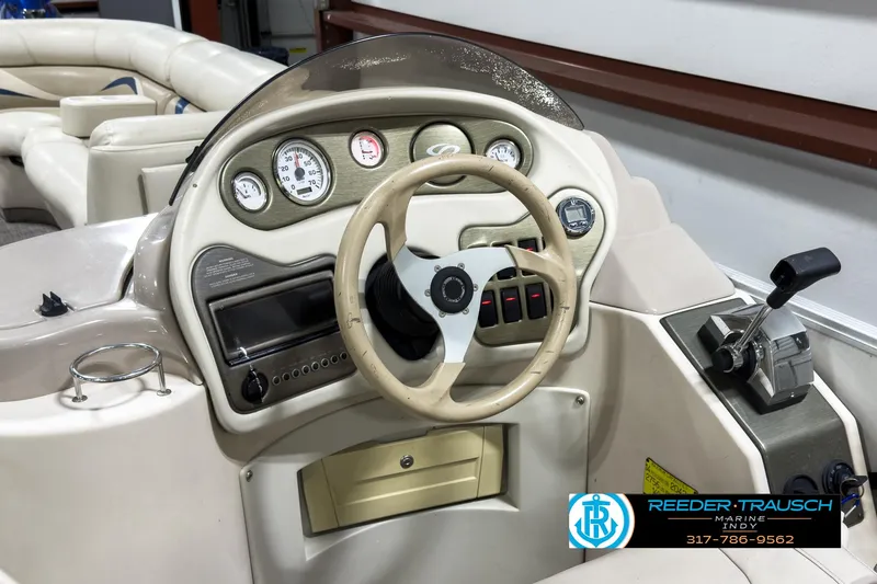 Slide: The Image of 2006 Crest Caribbean 2570 boat dashboard with steering wheel and controls. - 24