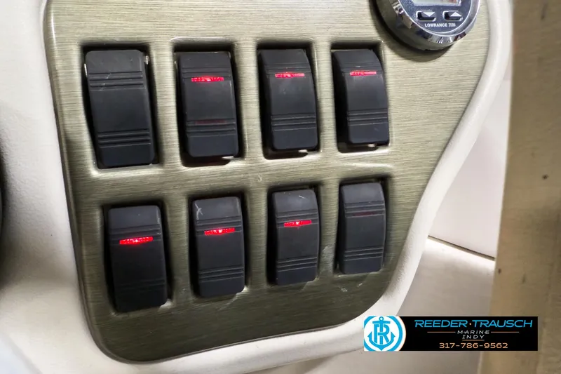 Slide: The Image of Control panel of 2006 Crest Caribbean 2570 boat with switches and gauge. - 29