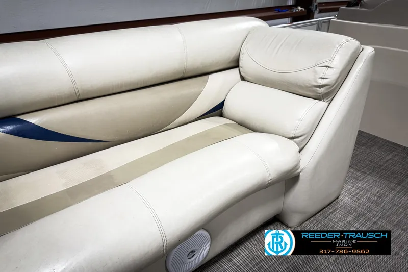 Slide: The Image of 2006 Crest Caribbean 2570 boat interior with beige seating and blue accents. - 31