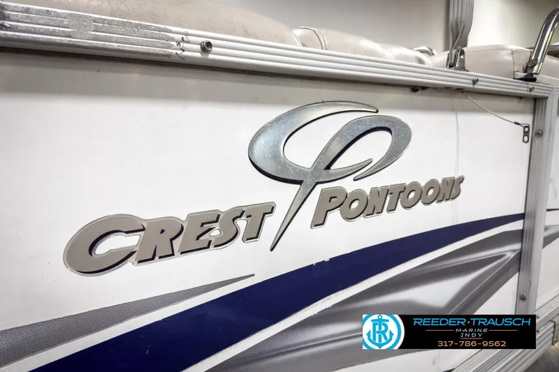 Slide: The Image of 2006 Crest Caribbean 2570 pontoon boat with logo and dealership branding. - 36