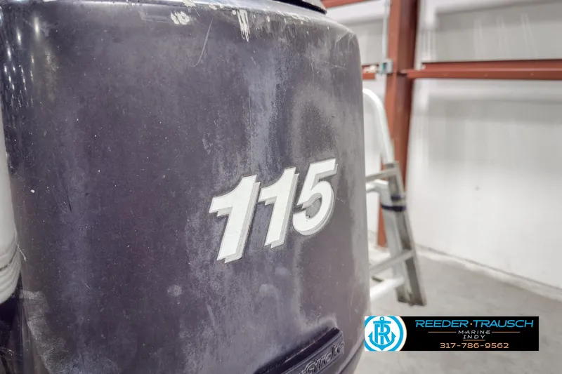Slide: The Image of Close-up of a 2006 Crest Caribbean 2570 boat engine with "115" marking. - 38