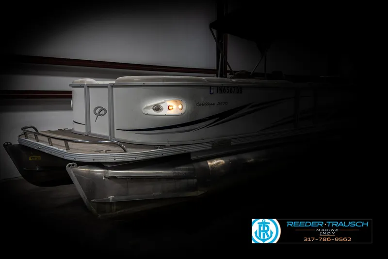 Slide: The Image of 2006 Crest Caribbean 2570 pontoon boat in storage, side view with logo. - 4