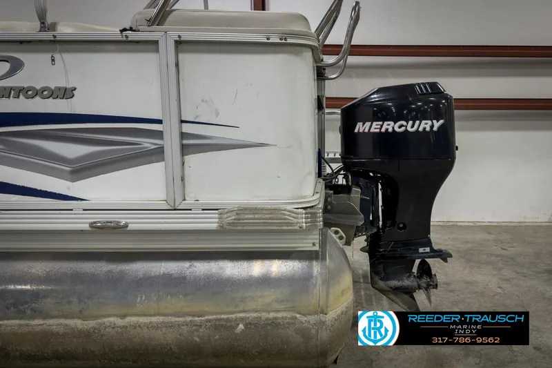 Slide: The Image of 2006 Crest Caribbean 2570 pontoon boat with Mercury outboard motor in a garage. - 40