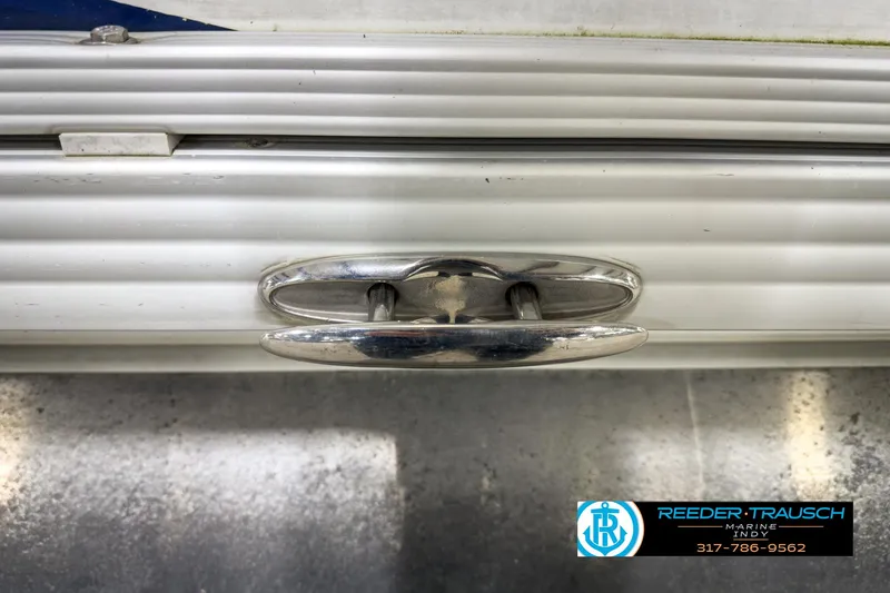 Slide: The Image of Close-up of a 2006 Crest Caribbean 2570 boat cleat with Reeder-Trausch Marine logo. - 42