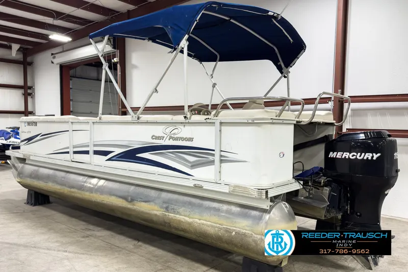 Slide: The Image of 2006 Crest Caribbean 2570 pontoon boat with Mercury outboard motor in a warehouse. - 6