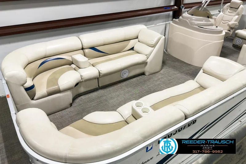 Slide: The Image of 2006 Crest Caribbean 2570 boat interior with beige seating and cup holders. - 9