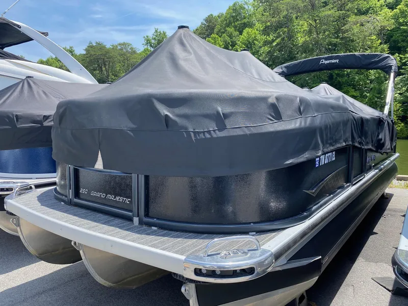 The Image of 2022 Premier 250 Grand Majestic RF pontoon boat with cover, parked outdoors. - 0