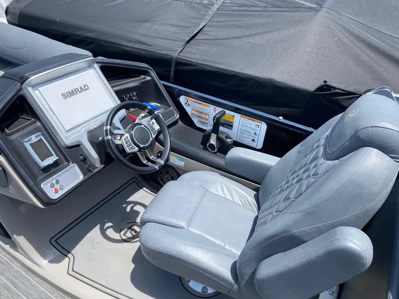 Slide: The Image of 2022 Premier 250 Grand Majestic RF boat cockpit with steering wheel and captain's chair. - 3