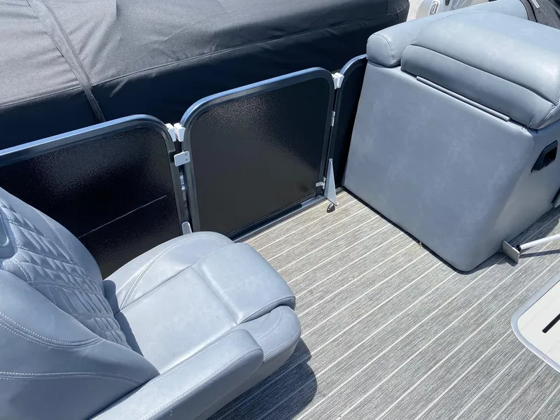 Slide: The Image of 2022 Premier 250 Grand Majestic RF boat interior with gray seating and striped flooring. - 4
