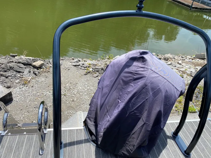 Slide: The Image of Covered grill on a 2022 Premier 250 Grand Majestic RF pontoon boat by a lake. - 7