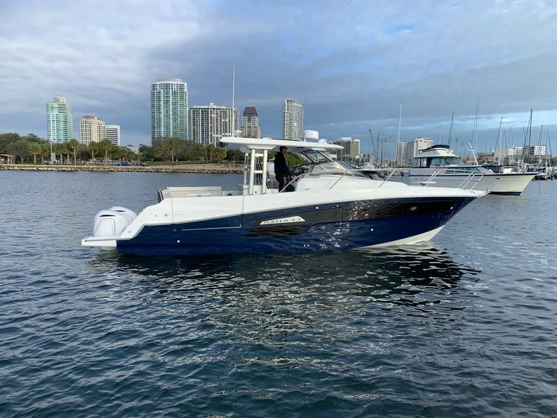 The Image of 2021 Jeanneau Leader 12.5 WA boat on water with city skyline background. - 0