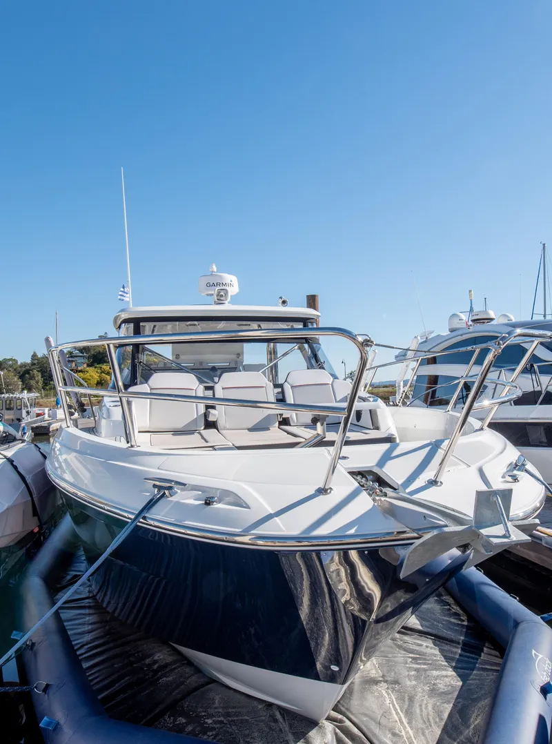 Slide: The Image of 2021 Jeanneau Leader 12.5 WA boat docked under clear blue sky. - 14