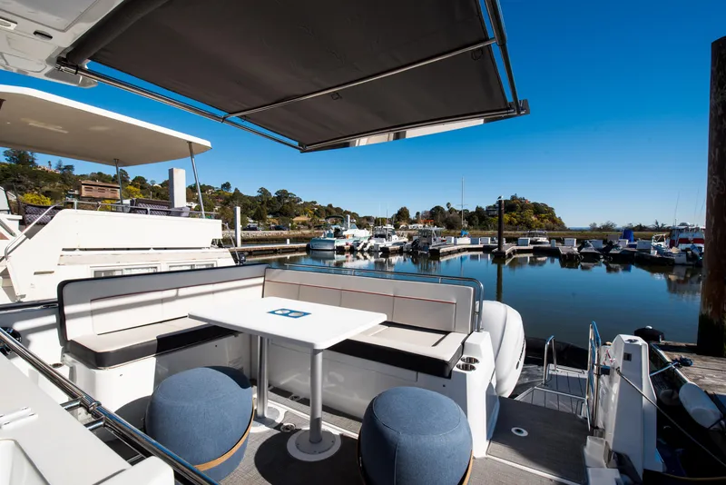 Slide: The Image of 2021 Jeanneau Leader 12.5 WA yacht with seating area in a marina. - 18