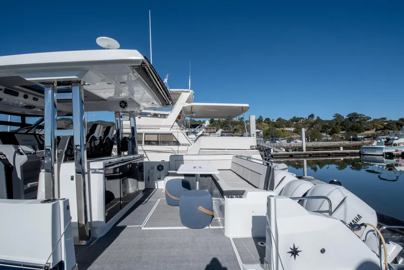 Slide: The Image of 2021 Jeanneau Leader 12.5 WA boat docked at marina, clear blue sky. - 2