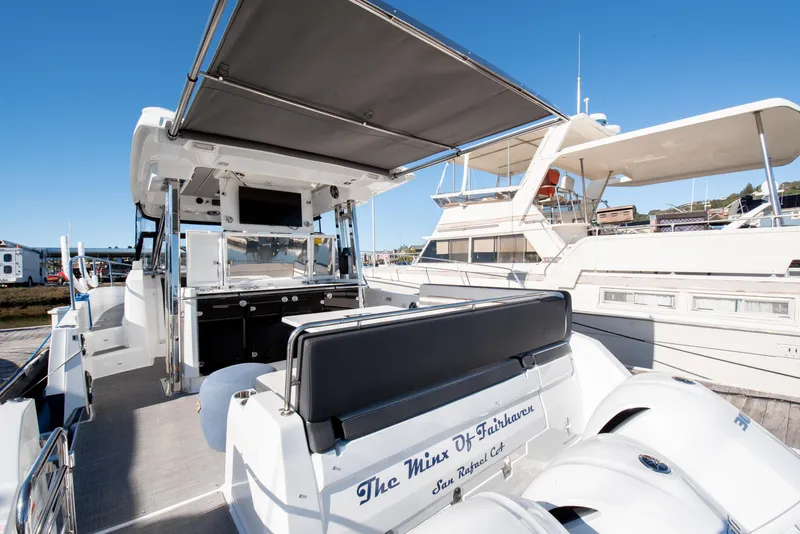 Slide: The Image of 2021 Jeanneau Leader 12.5 WA boat with spacious deck and canopy in marina. - 20