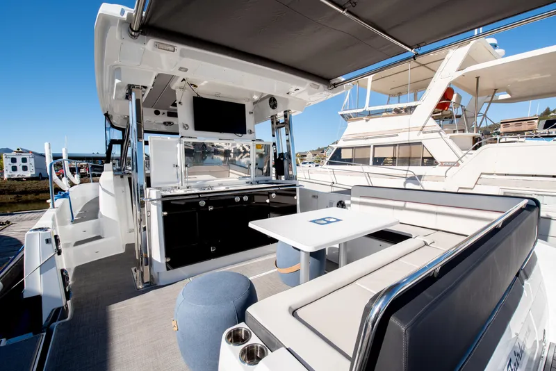 Slide: The Image of 2021 Jeanneau Leader 12.5 WA boat interior with seating and dining area. - 22