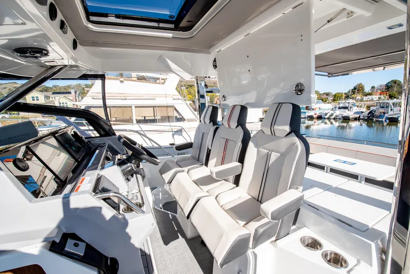 Slide: The Image of Interior of 2021 Jeanneau Leader 12.5 WA boat with modern seating and controls. - 29