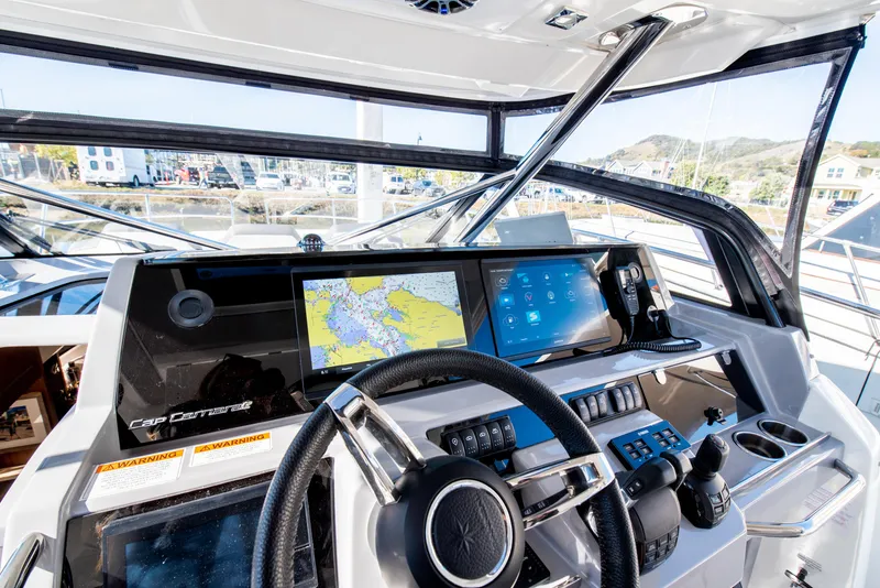 Slide: The Image of 2021 Jeanneau Leader 12.5 WA helm with advanced navigation system and steering wheel. - 31