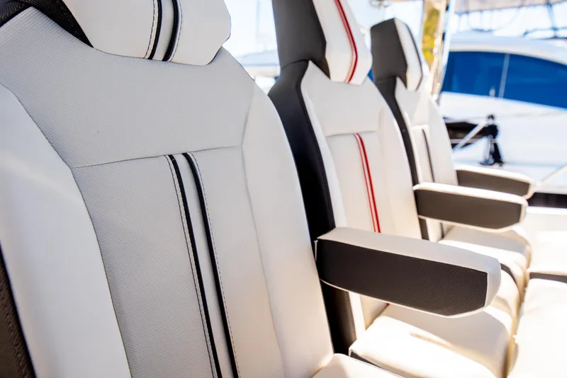 Slide: The Image of Luxury seating on 2021 Jeanneau Leader 12.5 WA boat, featuring stylish upholstery and armrests. - 34