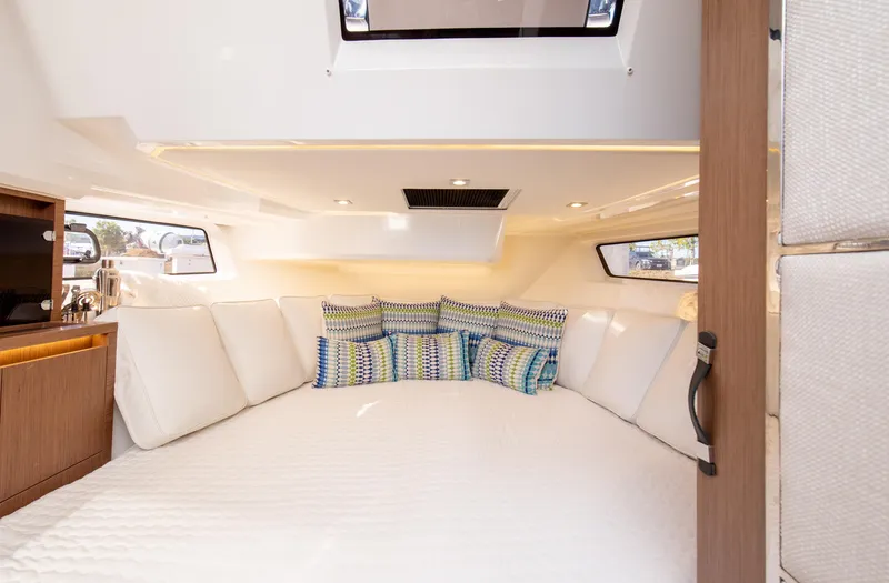 Slide: The Image of Interior cabin of 2021 Jeanneau Leader 12.5 WA with cozy bedding and cushions. - 48