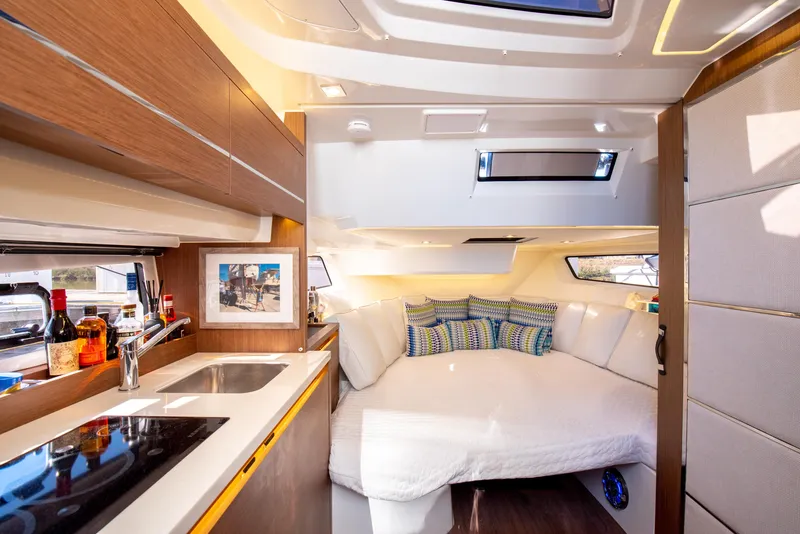 Slide: The Image of Luxurious interior of 2021 Jeanneau Leader 12.5 WA yacht with cozy bed and kitchenette. - 49