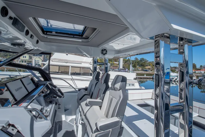 Slide: The Image of 2021 Jeanneau Leader 12.5 WA boat interior with modern seating and navigation controls. - 6