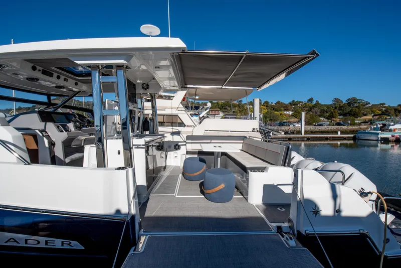 Slide: The Image of 2021 Jeanneau Leader 12.5 WA yacht with spacious deck and seating area at marina. - 7