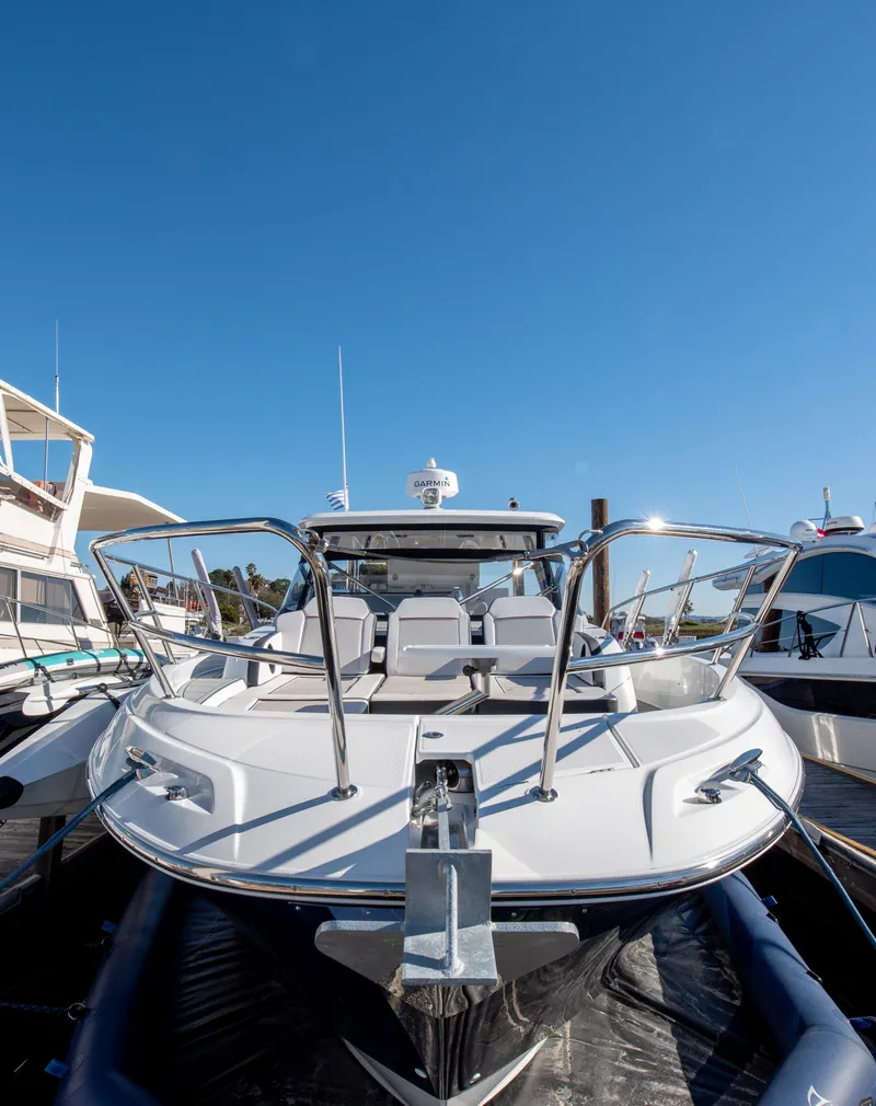 Slide: The Image of 2021 Jeanneau Leader 12.5 WA boat docked under clear blue sky. - 9