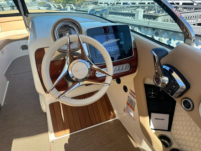 Slide: The Image of 2023 Chris-Craft Launch 28 GT dashboard with steering wheel and modern controls. - 10