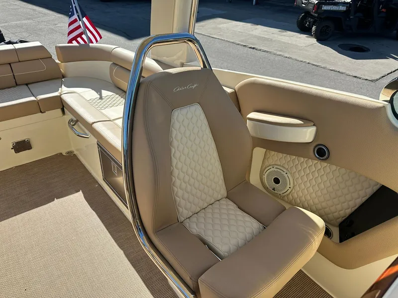 Slide: The Image of 2023 Chris-Craft Launch 28 GT interior with beige leather seating and American flag. - 18