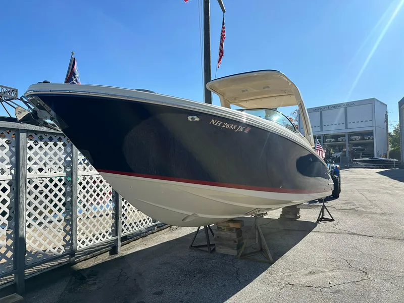 Slide: The Image of 2023 Chris-Craft Launch 28 GT boat on display in a marina setting. - 6