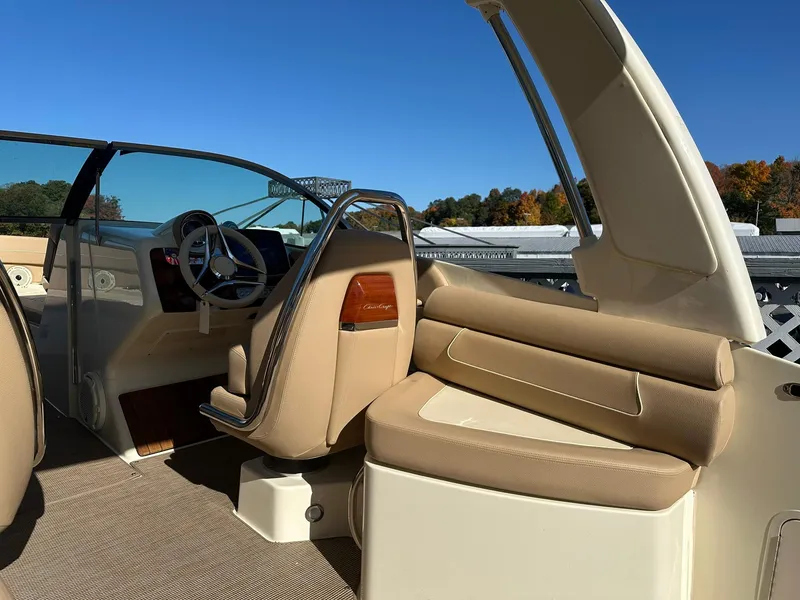 Slide: The Image of 2023 Chris-Craft Launch 28 GT interior with beige seating and steering wheel. - 9