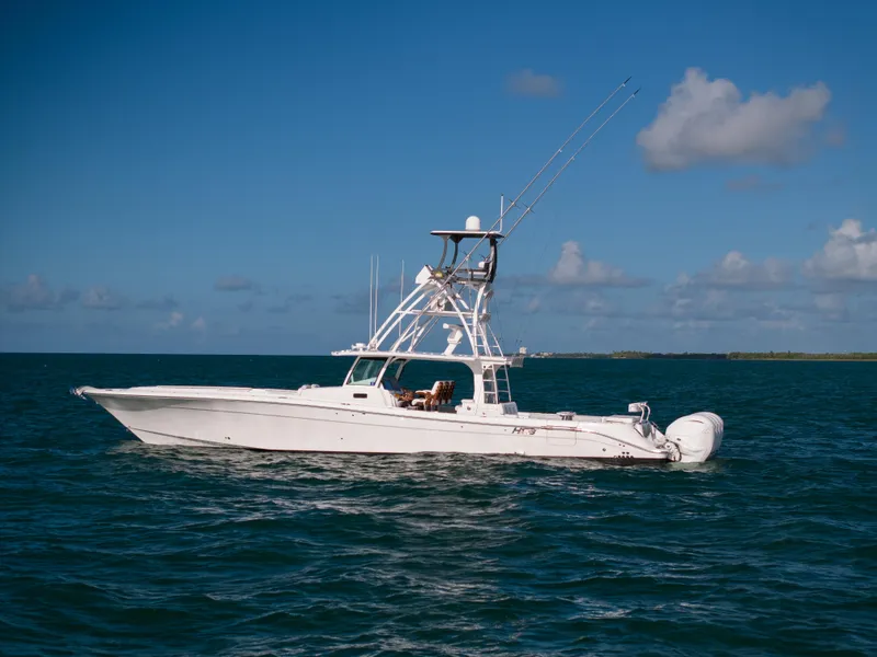 Slide: The Image of 2021 HCB 53 Sueños boat on open water under blue sky. - 1