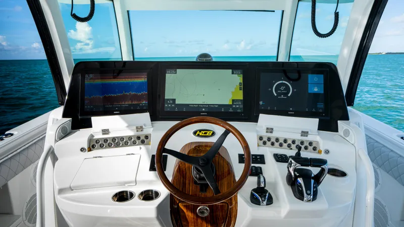 Slide: The Image of HCB 53 Sueños 2021 boat dashboard with advanced navigation systems and ocean view. - 11