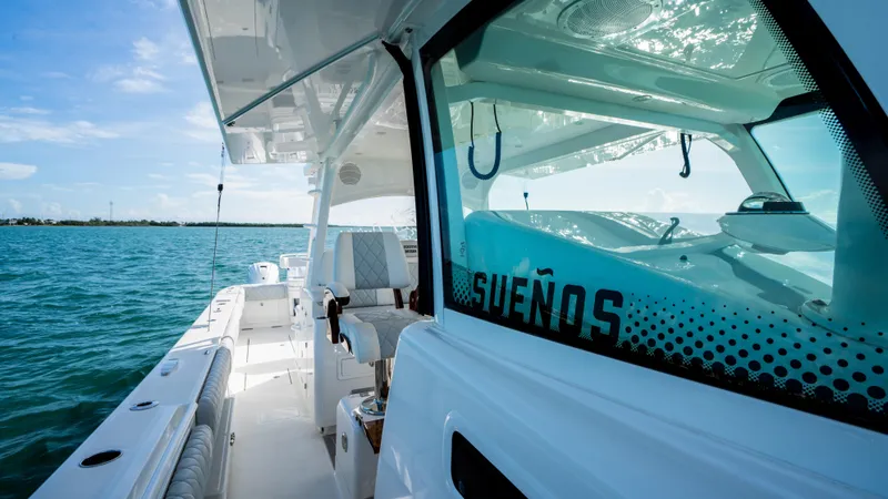Slide: The Image of 2021 HCB 53 Sueños boat on open water, showcasing sleek design and luxury features. - 15