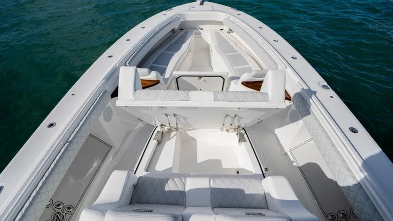 Slide: The Image of 2021 HCB 53 Sueños boat interior with white seating on blue water. - 18